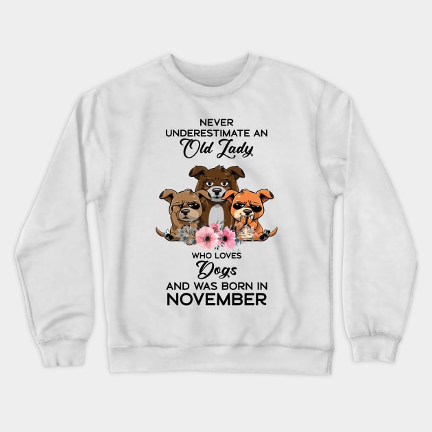Never Underestimate An Old Woman Who Loves Dogs And Was Born In November Crewneck Sweatshirt by Happy Solstice